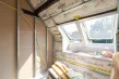 Eingebautes Dachflächenfenster, daneben die verklebte Dampfbremse und Mineralwolle